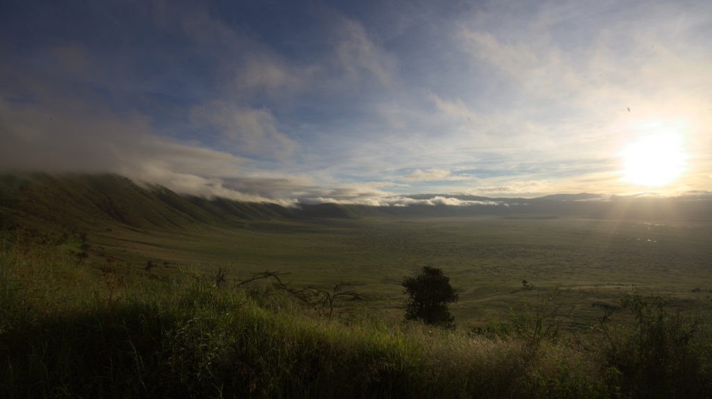 Slowly the sun wins from the clouds and spreads its light into the crater.